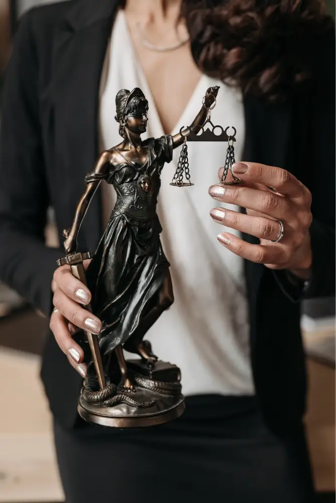 Lawyers holding the bronze statue of Lady Justice.